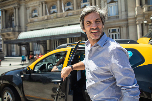 Mature man getting out of the cab