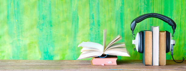 istock audio book concept with open book and headphones,  good copy space 1210123598