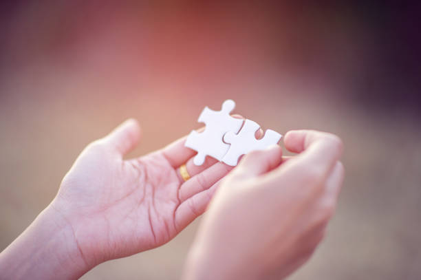 istock Hands and white jigsaw puzzles Close-up image and integration Business concept and unity 1210126735