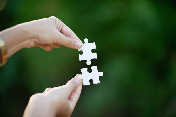 istock Hands and white jigsaw puzzles Close-up image and integration Business concept and unity 1210126757