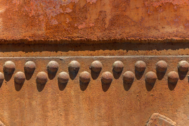 Rusty metal sheet texture with weld marks and large rivets