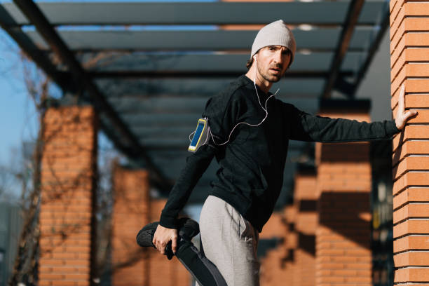 istock Male athlete stretching his leg while exercising outdoors. 1210129548