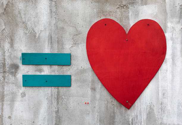 istock Blue equal sign and red wooden heart 1210131323