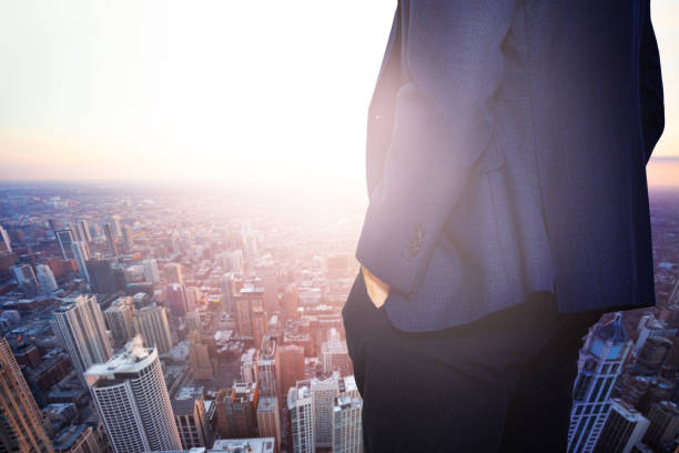 istock Businessman in suit at Chicago sunset view window 1210135871