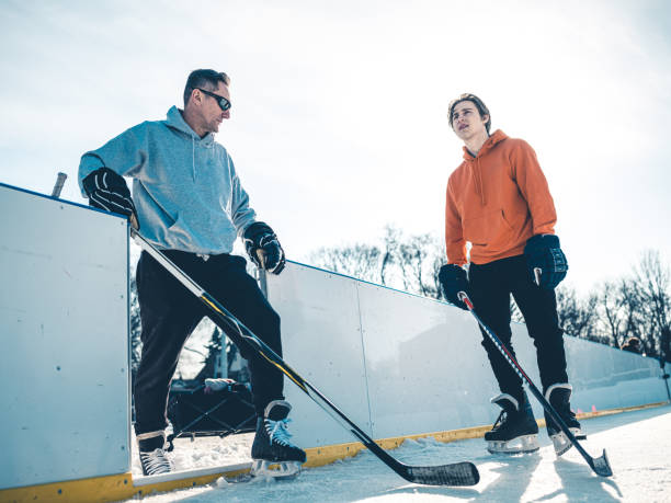 istock Father and son playing hockey outdoors 1210136018