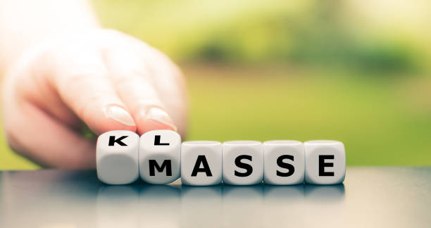 istock Quality instead of quantity. Hand turns dice and changes the German word 