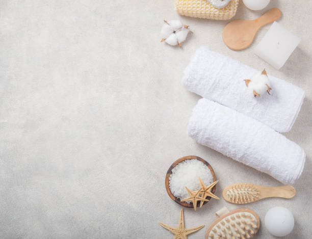 istock Spa beauty cosmetic products and tools on white concrete  background. Top view copy space 1210139259