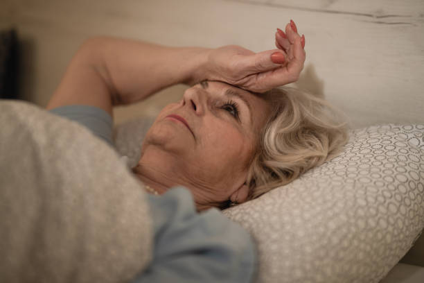 istock Sleepless senior woman thinking of something while lying down in bed. 1210141056