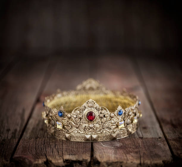 istock Gold Crown on an Old Wood Background 1210141944