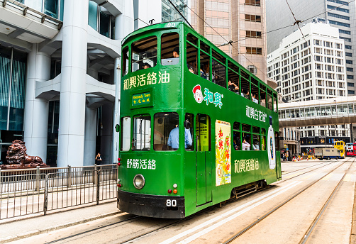 Hong Kong - July 17, 2019: Famous double-decker trams on the street of Hong Kong Island