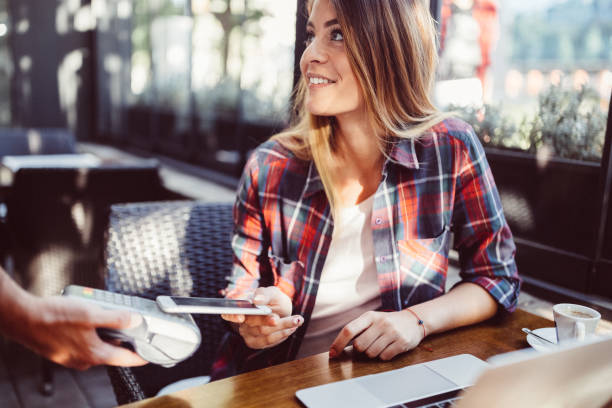 istock Customer in cafe paying contactless with smartphone 1210142521