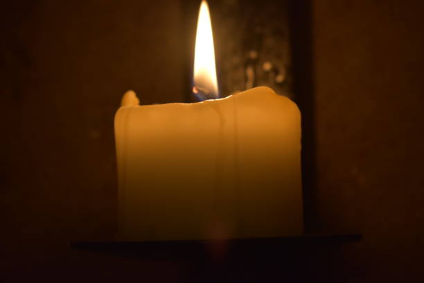 istock Light from candle illuminates in the the darkness 1210144626
