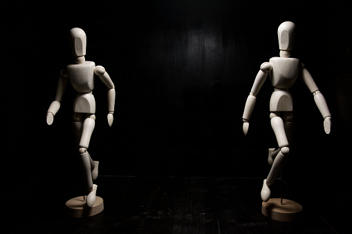 Two drawing mannequins running and facing each other