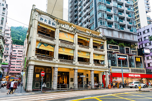 Hong Kong - July 19, 2019: Busy Wan Chai street with Wo Cheong Pawnshop in Hong Kong. It is one of the busy business zones in Hong Kong