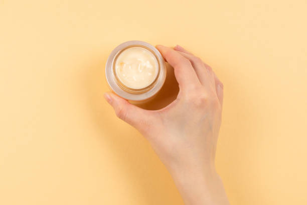 istock Hand cream and woman hands on a beige background. 1210146713