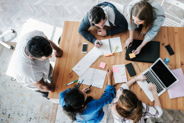 istock overhead view on young business people working together on desk 1210148632