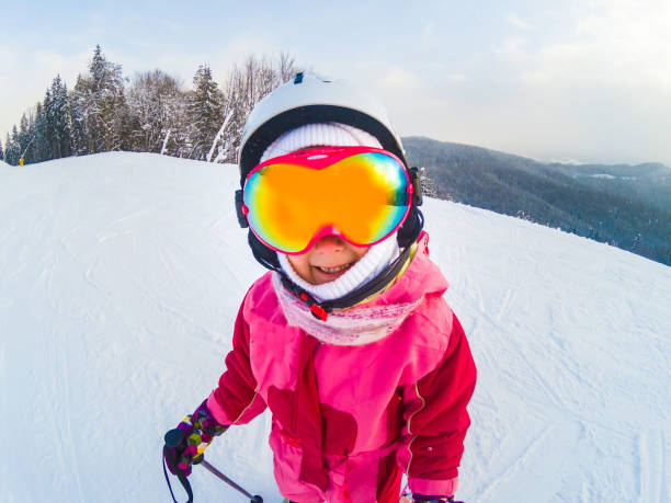 istock Skiing - little skier skiing on ski slope 1210150543
