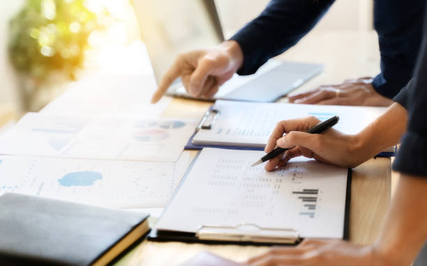 istock Business sales consultant discussing in data documents at modern office. 1210151932