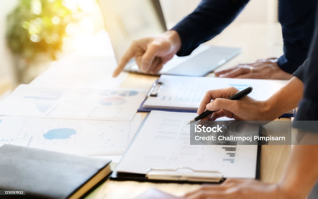 Business sales consultant discussing in data documents at modern office. Tax Form Stock Photo