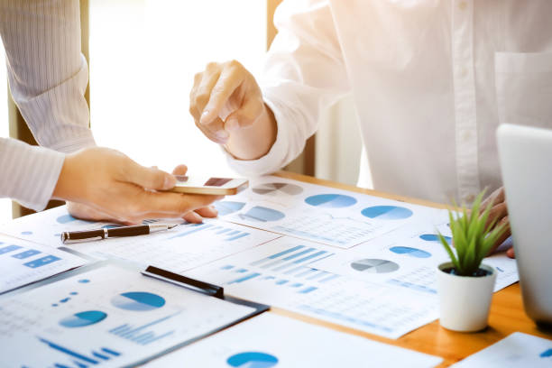 istock Business sales consultant discussing in data documents at modern office. 1210152068