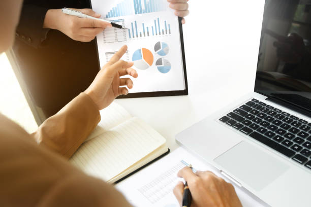 istock Business sales consultant discussing in data documents at modern office. 1210152083