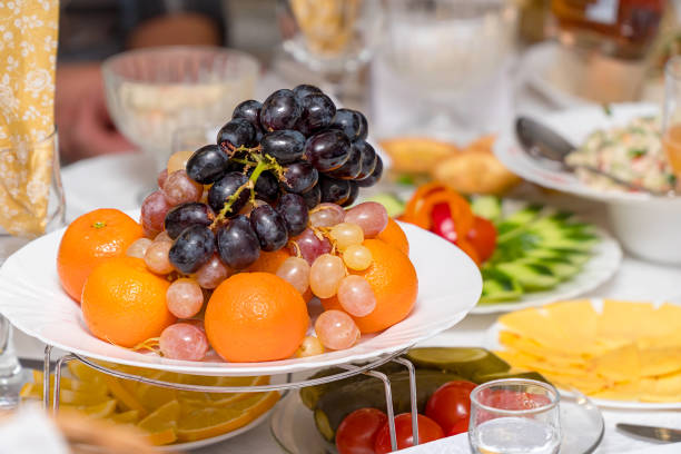 istock Fruits-grapes, oranges, tangerines, lemon on holiday table 1210156945