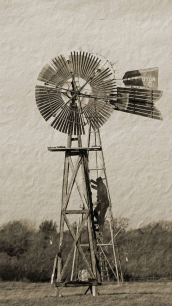 istock Old Metal windmill standing tall in a field 1210157371
