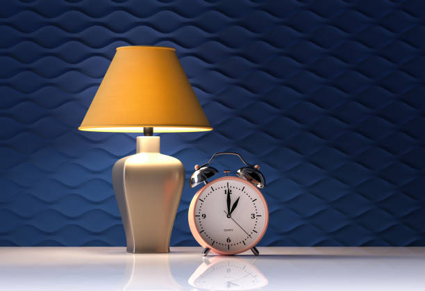 istock Yellow lamp and alarm clock on blue background - interior - 3d rendering 1210160464