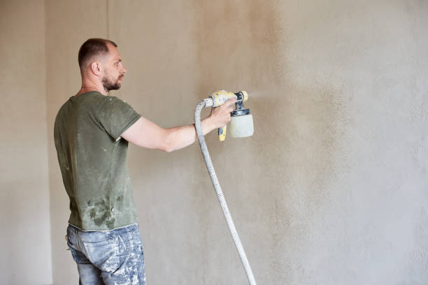 istock Male hands hold the tool the paint spray. Apartment remodel. 1210160577