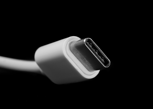 Micro USB type C or USB-C plug and white cable close-up.
