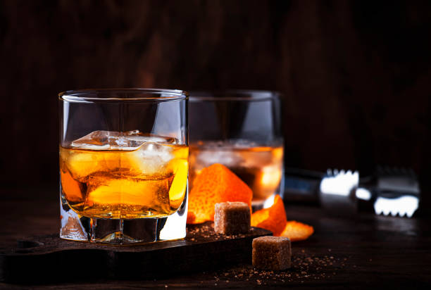 istock Alcoholic old fashioned cocktail with orange slice, cherry and orange peel garnish 1210161963
