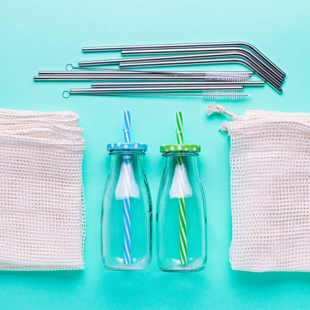 istock Glass jars, reusable straws for drink, mesh bags on blue table top. Flat lay zero wate concept or sustainable lifestyle. Plastic free background overhead 1210162006