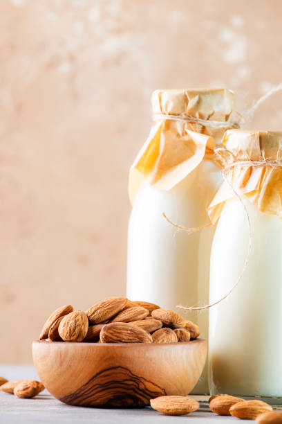 istock Almond milk with almond on brown table 1210162064