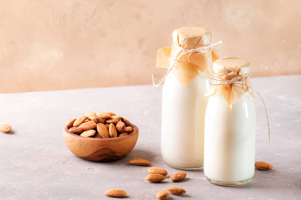 istock Almond milk with almond on brown table 1210162088