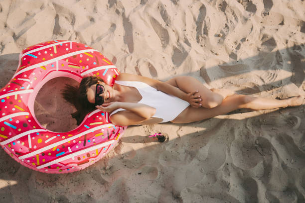 istock Tender attractive woman posing and lying on sandy seaside 1210162933