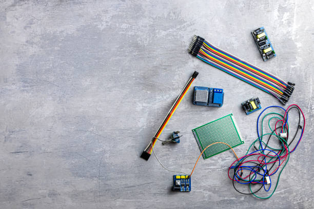 istock electrician, electronics. different wires and electrical details on a gray wooden background. Place for text 1210163029