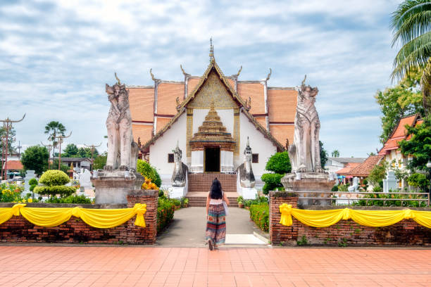 istock Young woman walking into Ancient temple 1210163938