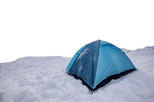 Blue tent camping in snowy hill on white background