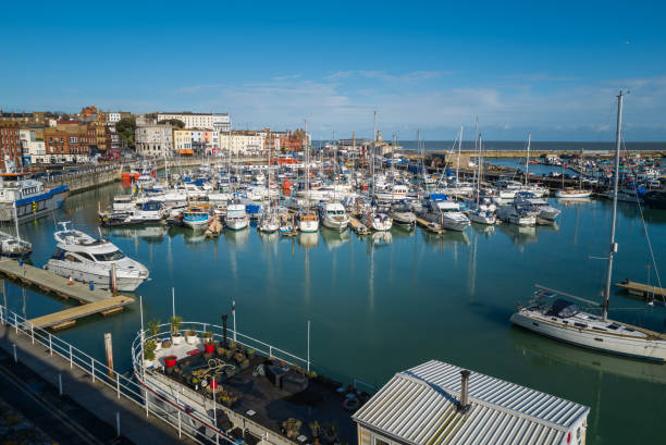Yachts moored in the marina of the impressive historic Royal Harbour on a cool but bright winter day. Ramsgate, England - March 3 2020 Yachts moored in the marina of the impressive historic Royal Harbour on a cool but bright winter day. ramsgate stock pictures, royalty-free photos & images