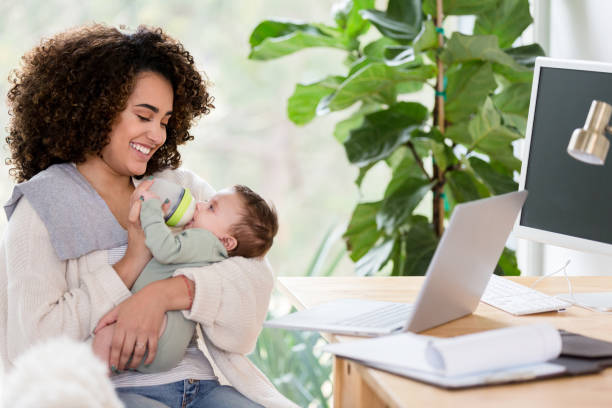 istock Confident working mother feeds baby boy 1210165382
