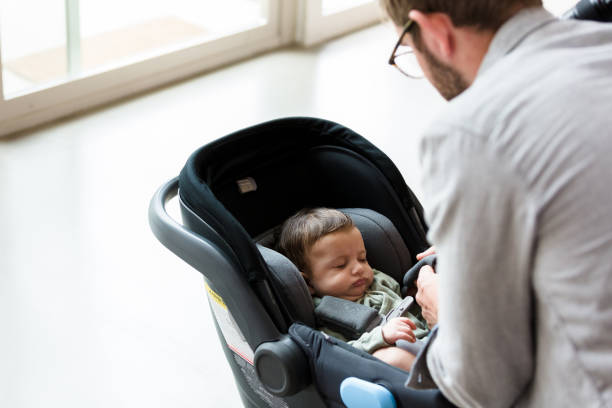 istock New dad secures baby into infant carrier 1210165399