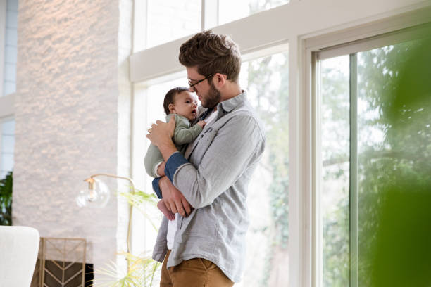 istock Loving father cares for infant son 1210165433