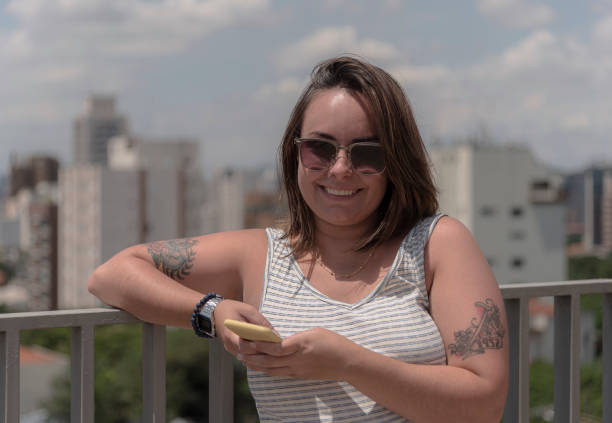 istock Young woman smiling on rooftop 1210167199