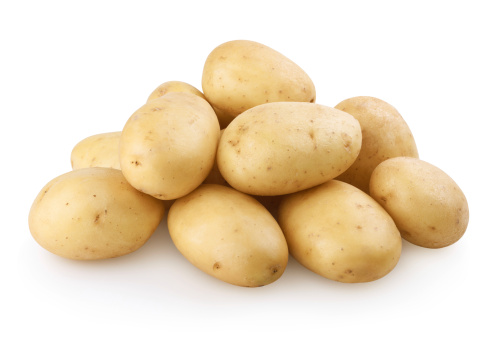 Fresh potatoes with slices isolated on white background