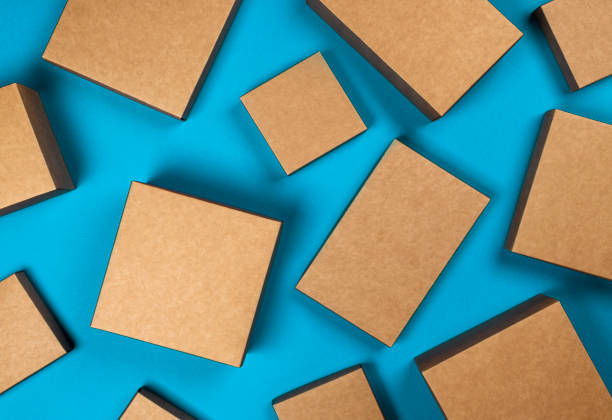 istock Brown cardboard boxes on blue background, top view 1210170669