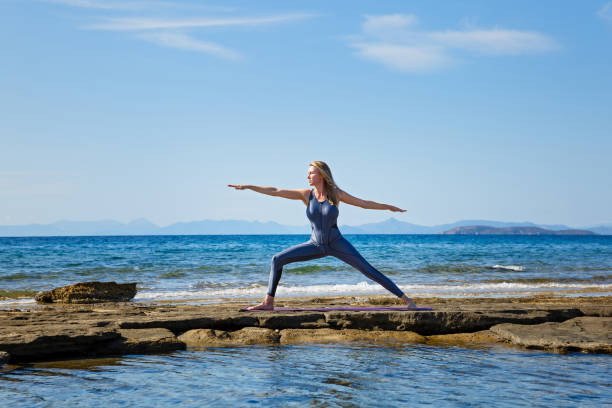 istock Woman doing yoga on the beach 1210172436