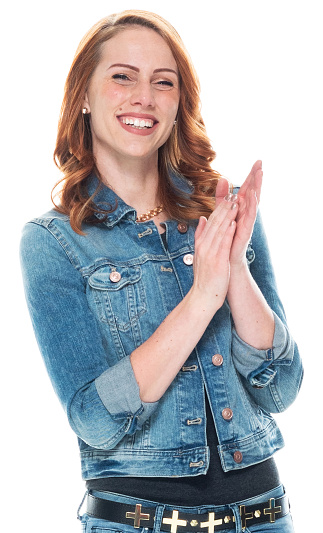 One person of aged 20-29 years old who is beautiful with long hair caucasian female standing in front of white background wearing jacket who is excited and clapping