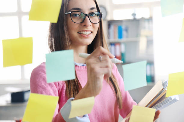 istock Business woman looking at sticky notes 1210172801