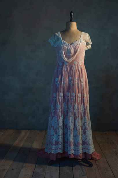 istock Pink victorian dress on vintage mannequin bust in empty room. 1210173375