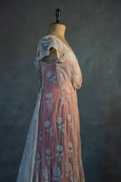 istock Vintage mannequin bust with pink victorian dress. Side view. 1210173926